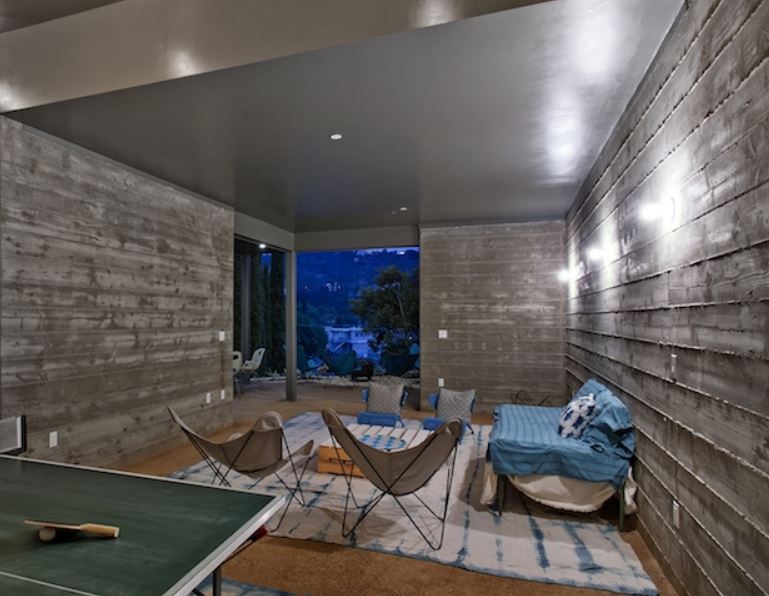 Covered patio with seating and large windows at dusk, Santa Barbara, CA