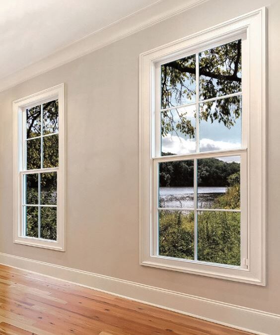 Bright glass windows frame a peaceful water view in this room, replacement windows Santa Barbara, CA