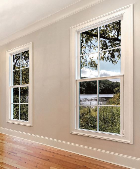 Bright glass windows frame a peaceful water view in this room, replacement windows Santa Barbara, CA