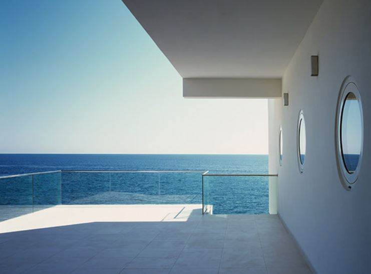 Round windows overlook the ocean from a modern terrace, replacement windows Ventura, CA